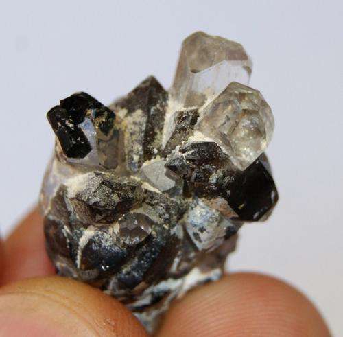 Perfect terminated Silver Topaz crystals with tourmaline crystals